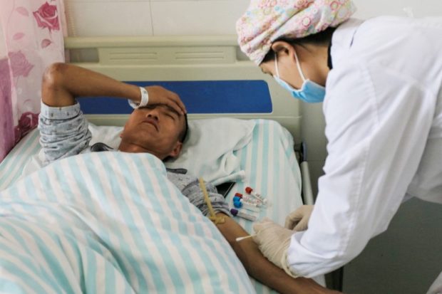 This photo taken on May 23, 2021 shows a runner receiving treatment at a hospital after surviving from extreme weather when competing in a 100-kilometre cross-country mountain race, near the city of Baiyin, in China's northwestern Gansu province