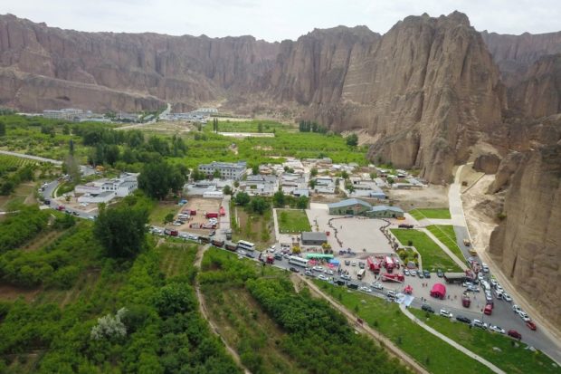 This aerial photo taken on May 23, 2021 shows rescue vehicles preparing to leave after finishing search for runners who were competing in a 100-kilometre cross-country mountain race when extreme weather hit the area, leaving at least 20 dead, near the city of Baiyin, in China's northwestern Gansu province