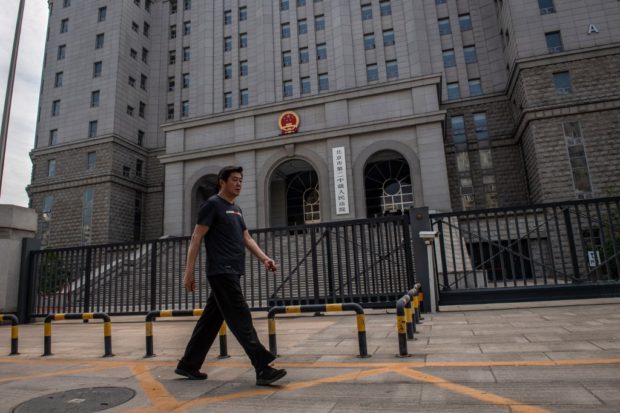 A man walks past the Beijing Second Intermediate People's Court before the trial of Australian academic Yang Jun, also known as Yang Hengjun, on espionage charges in Beijing on May 27, 2021. 