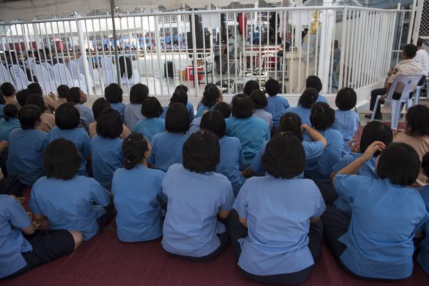 In this file photo taken on February 8, 2018 prison inmates sit together to attend a special entertainment program at a prison in the central Thai province of Nakhon Nayok. - A coronavirus surge sweeping through Thailand's prisons has thrown the spotlight on conditions in the kingdom's overcrowded jails, where some inmates have less sleeping space than the inside of a coffin. (Photo by LILLIAN SUWANRUMPHA / AFP) / To go with 'THAILAND-HEALTH-VIRUS-PRISON,FOCUS' by Lisa MARTIN and Pathom SANGWONGWANICH