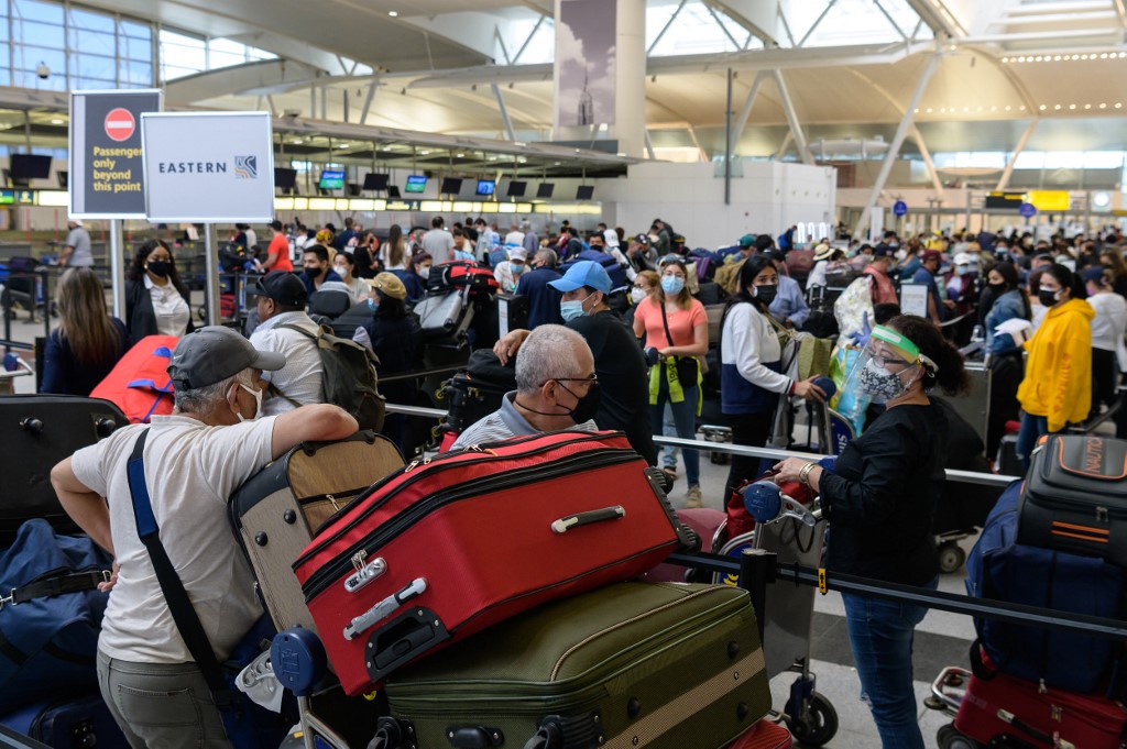 Travelers wait in line at John F. Kennedy (JFK) Airport ahead of Memorial day weekend on May 28, 2021 in New York City. 