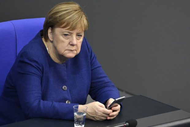  In this file photo taken on December 08, 2020 German Chancellor Angela Merkel uses her mobile phone during a debate at the Bundestag (lower house of parliament) in Berlin. - The US spied on top politicians in Europe, including German Chancellor Angela Merkel, from 2012 to 2014 with the help of Danish intelligence, Danish and European media reported on Sunday. Danish public broadcaster Danmarks Radio (DR) said the US National Security Agency (NSA) had eavesdropped on Danish internet cables to spy on top politicians and high-ranking officials in Germany, Sweden, Norway and France.