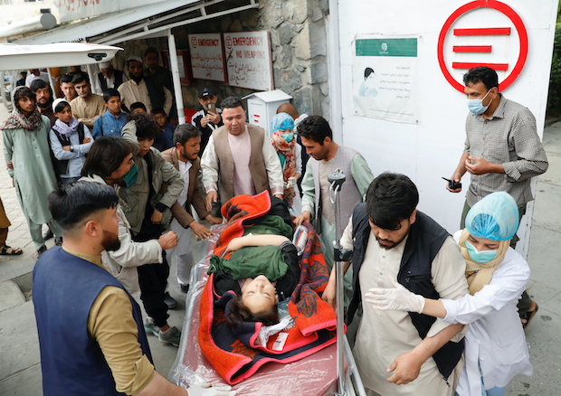 An injured woman is transported  to a hospital after a blast in Kabul