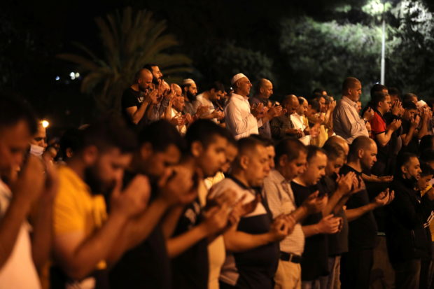 Palestinians pray on Laylat al-Qadr during the holy month of Ramadan, at the compound that houses Al-Aqsa Mosque, known to Muslims as Noble Sanctuary and to Jews as Temple Mount, in Jerusalem's Old City, May 8, 2021. REUTERS/Ammar Awad
