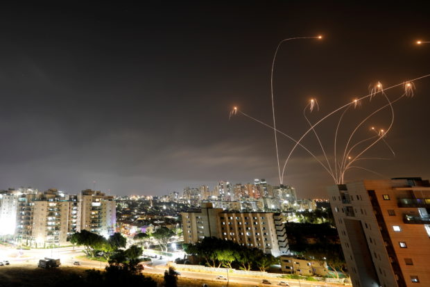 Streaks of light are seen as Israel's Iron Dome anti-missile system intercepts rockets launched from the Gaza Strip towards Israel, as seen from Ashkelon