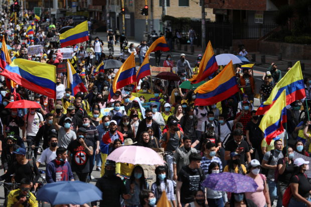 Demonstrators take part in a protest demanding government action to tackle poverty, police violence and inequalities in healthcare and education systems, in Bogota, Colombia, May 9, 2021