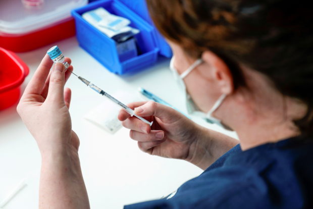A healthcare professional prepares a dose of the Pfizer coronavirus disease (COVID-19) vaccine as high-risk workers receive the first vaccines in the state of Victoria's rollout of the program, in Melbourne, Australia, February 22, 2021