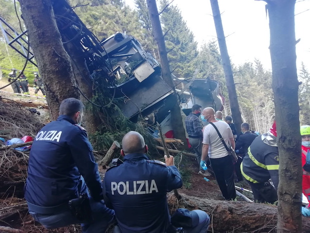 Police and rescue service members are seen near the crashed cable car after it collapsed in Stresa