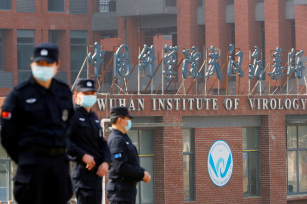 Security personnel keep watch outside the Wuhan Institute of Virology during the visit by the World Health Organization (WHO) team tasked with investigating the origins of the coronavirus disease (COVID-19), in Wuhan, Hubei province, China February 3, 2021. REUTERS/Thomas Peter/File Photo