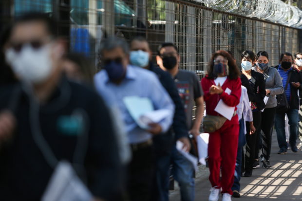  School workers line up before receiving a dose of China's CanSino COVID-19 vaccine during a mass vaccination for teachers and school staff against coronavirus disease in Mexico City, Mexico May 18, 2021