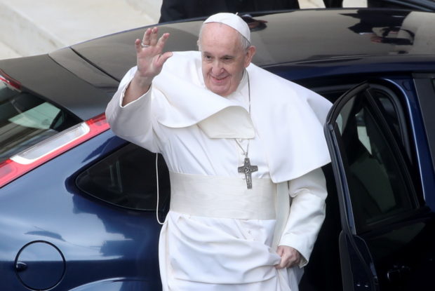 Pope Francis waves before leaving after the weekly general audience, in San Damaso courtyard, at the Vatican, May 19, 2021. 