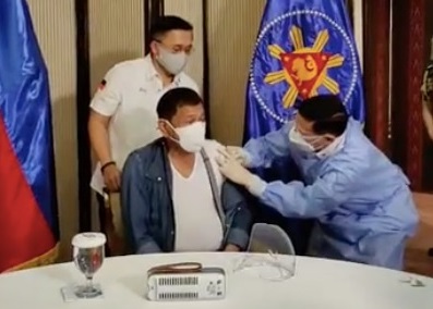 Duterte receiving vaccine shot inside Malacanang