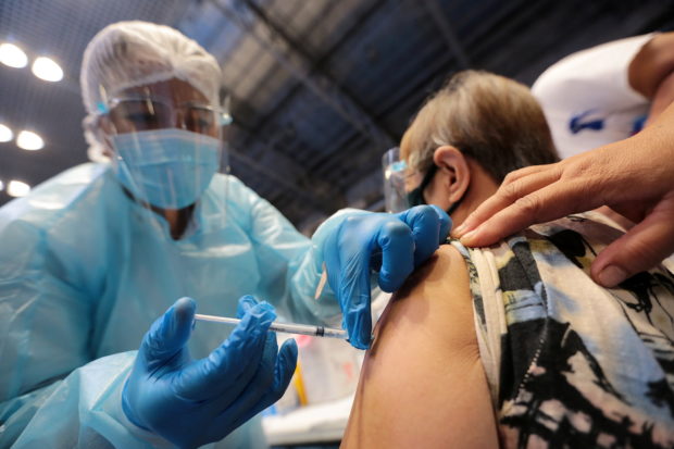 PRIORITY SECTOR A nurse injects a senior citizen with the Russian-made Sputnik V vaccine at the Makati Coliseum. —GRIG C. MONTEGRANDE