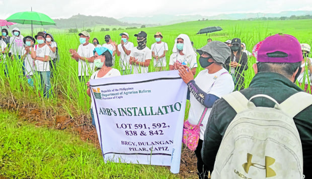 OUR LAND Agrarian reform beneficiaries in Pilar town, Capiz province, formalize on May 11 their possession of land granted to them by the government more than 23 years ago. —PHOTO COURTESY OF TASK FORCE MAPALAD