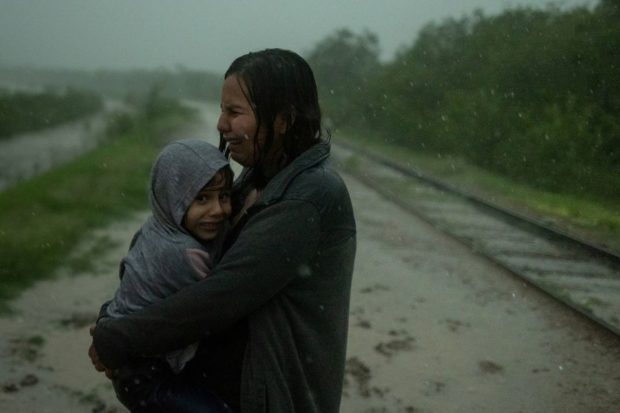 Rains drench migrants crossing Rio Grande river into United States