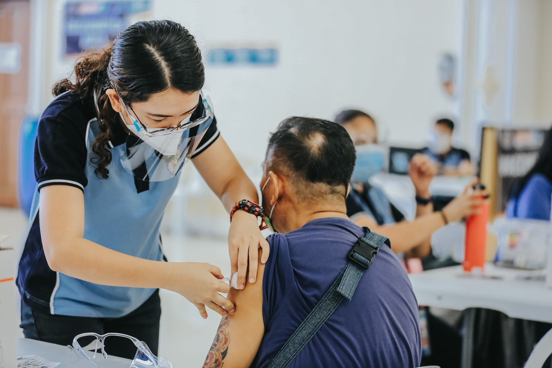 A city health personnel vaccinates an elderly man in Pampanga’s capital city on May 24. Photo from the City of San Fernando Information Office