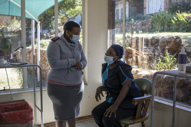 vAn health care worker registers a caregiver of the SAVF Evanna Tehuis old age home ahead of a vaccination run with Pfizer vaccines near Klerksdorp, on May 19, 2021. South Africa is resuming its COVID-19 coronavirus Phase 2 vaccination rollout programme which targets vulnerable groups who are 60 years and older. (Photo by Michele Spatari / AFP)