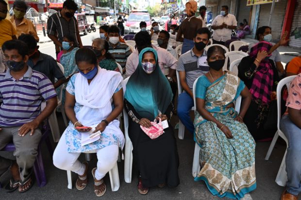 People wait to get a dose of the Covaxine Covid-19 coronavirus vaccine at a vaccination camp in Chennai on June 4, 2021. (Photo by Arun SANKAR / AFP)
