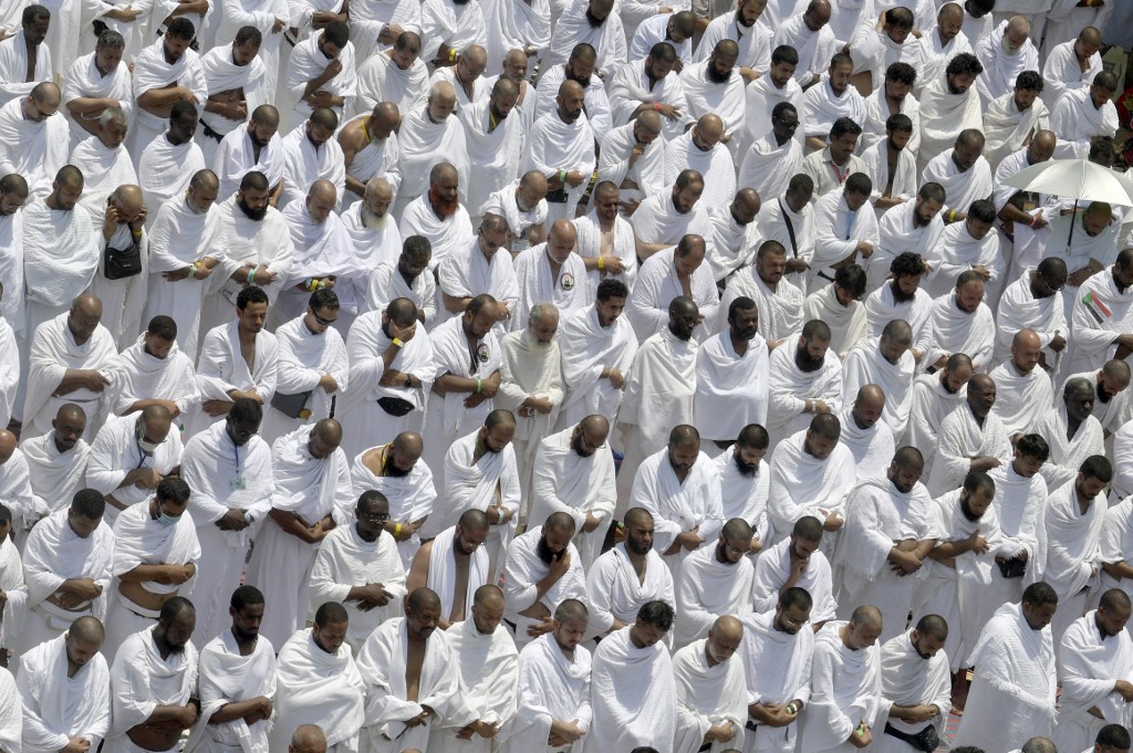 Muslim pilgrims pray outside the Namirah mosque at Mount Arafat, also known as Jabal al-Rahma (Mount of Mercy), southeast of the Saudi holy city of Mecca, as the climax of the Hajj pilgrimage approaches. 