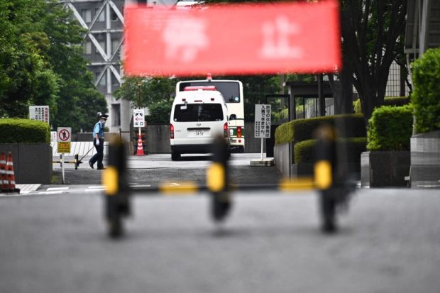 A bus believed to be carrying former US special forces member Michael Taylor and his son Peter, who allegedly staged the operation to help fly former Nissan chief Carlos Ghosn out of Japan in 2019, arrives at the Tokyo district court in Tokyo on June 14, 2021. (Photo by Philip FONG / AFP)