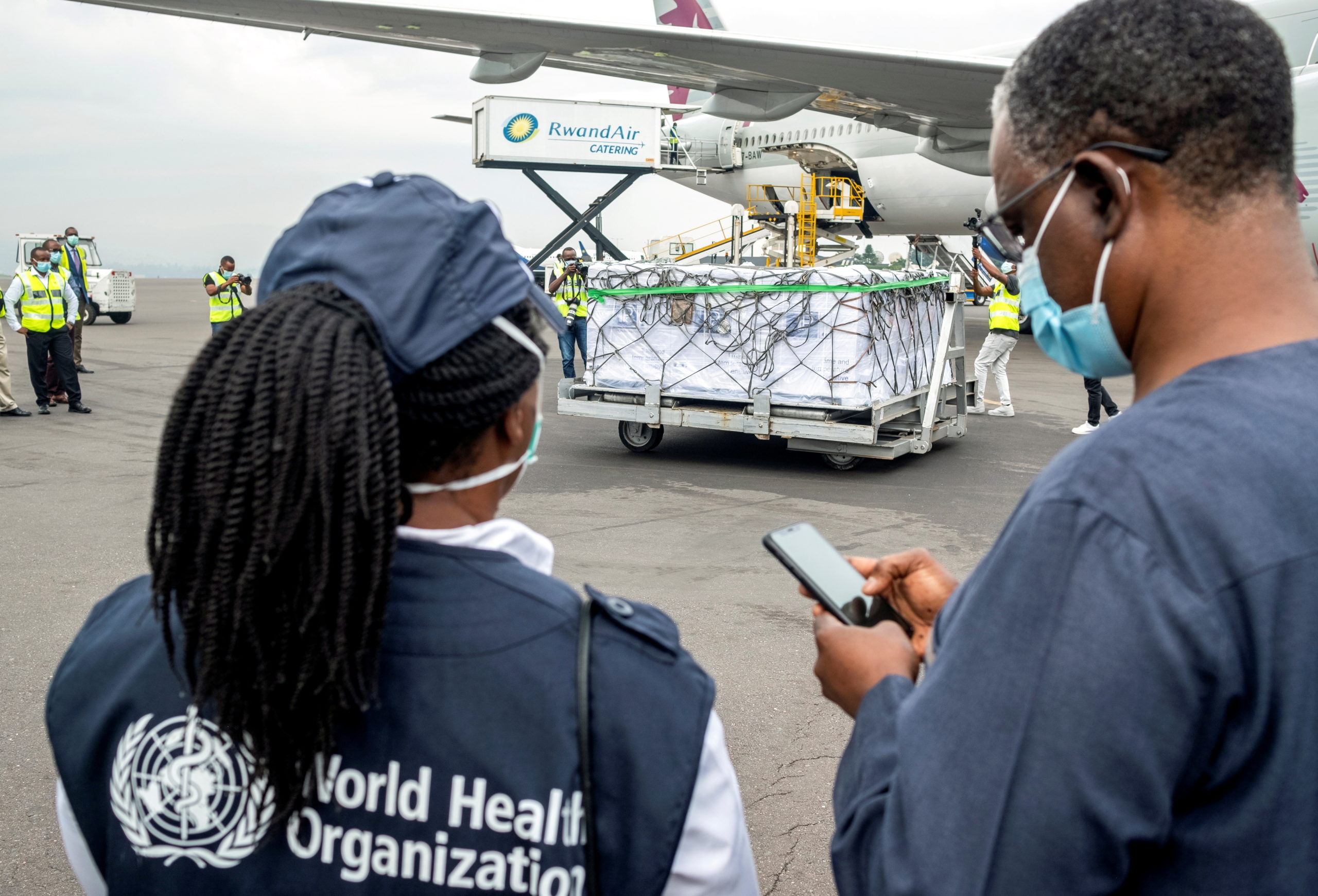 FILE PHOTO: World Health Organization (WHO) officials attend the arrival of the first batch of vaccines against the coronavirus disease (COVID-19) at the Kigali international airport in Kigali, Rwanda March 3, 2021. REUTERS/Jean Bizimana/File Photo