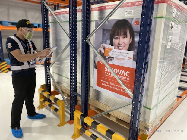 Customs worker inspect vaccine shipment