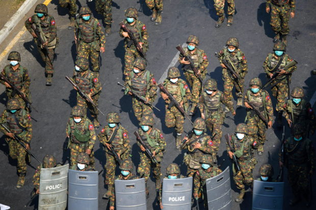 Myanmar soldiers walk along a street during a protest against the military coup in Yangon, Myanmar, February 28, 2021. REUTERS/Stringer/File Photo