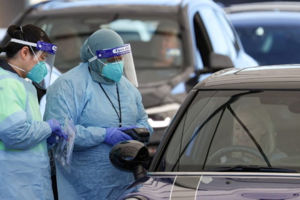Medical workers administer tests at the Bondi Beach drive-through coronavirus disease (COVID-19) testing centre in the wake of new positive cases in Sydney, Australia, June 17, 2021.  REUTERS/Loren Elliott/File Photo
