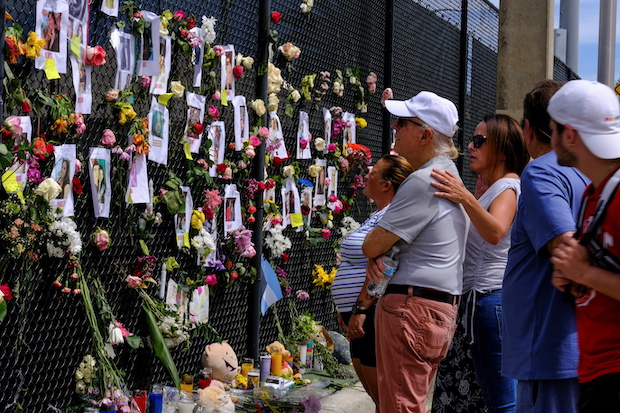 A memorial site created by neighbors in front of Champlain Towers South, in Surfside