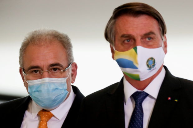 Brazil's Health Minister Marcelo Queiroga and Brazil's President Jair Bolsonaro arrive for a ceremony of release of resources for Primary Health Care in combat of the coronavirus disease (COVID-19), at the Planalto Palace in Brasilia, Brazil May 11, 2021