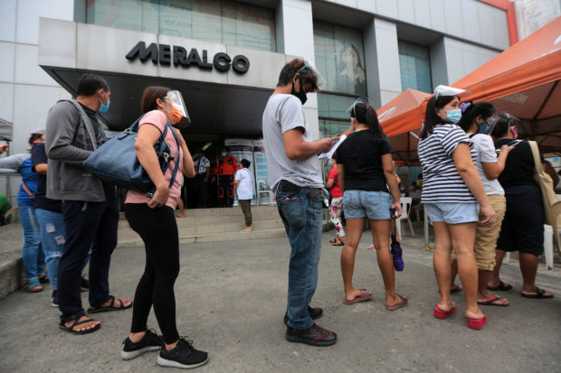 Consumer in front of a Meralco office. STORY: Power rate hike seen after genco stops grid supply