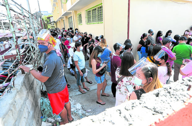 Residents belongs to A1-social workers, A2-senior citizens, A3-persons with commorbidities and A5-indigent population wait for their turn to be vaccinated with Pfizer vaccine against Covid-19 at the Caloocan Central Elementary School, Caloocan City on Wednesday, June 16, 2021. INQUIRER PHOTO / NINO JESUS ORBETA