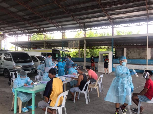 Health workers facilitate the collection of specimens in Badoc, Ilocos Norte