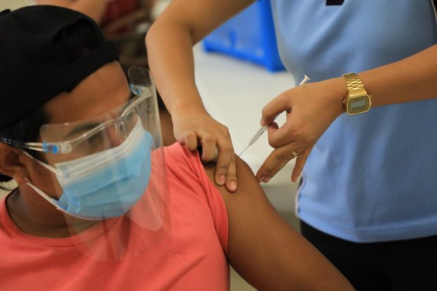 A frontliner belonging to the A1 priority group receives a COVID-19 vaccine. (File photo from the City of San Fernando Information Office)