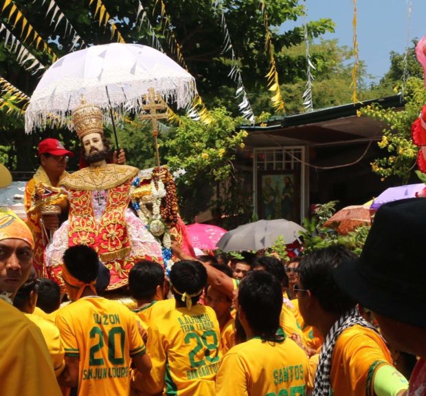 Devotees carry life-size image of Saint Peter for a procession during feast in Apalit Pampanga