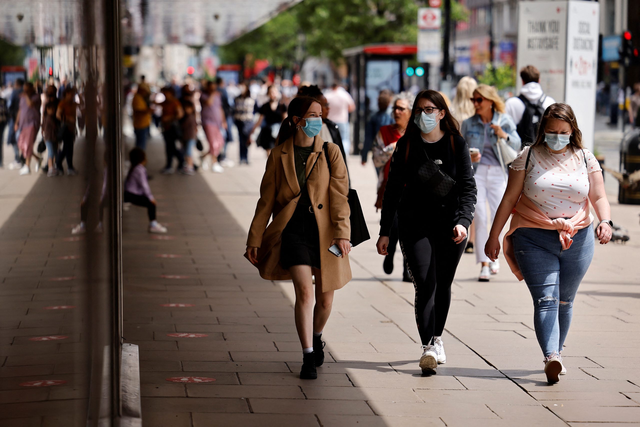 Pedestrians wearing a face mask or covering due to the COVID-19 pandemic, walk along Oxford Street in central London on June 6, 2021. - The Delta variant of the coronavirus, first discovered in India, is estimated to be 40 percent more transmissible than the Alpha variant that caused the last wave of infections in the UK, Britain's health minister said Sunday. (Photo by Tolga Akmen / AFP)