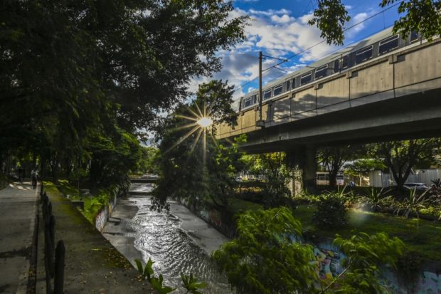 The metro passes by a green corridor in Medellin, Colombia
