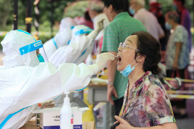 A woman receives a nucleic acid test for the Covid-19 coronavirus in Nanjing, in eastern Jiangsu province.