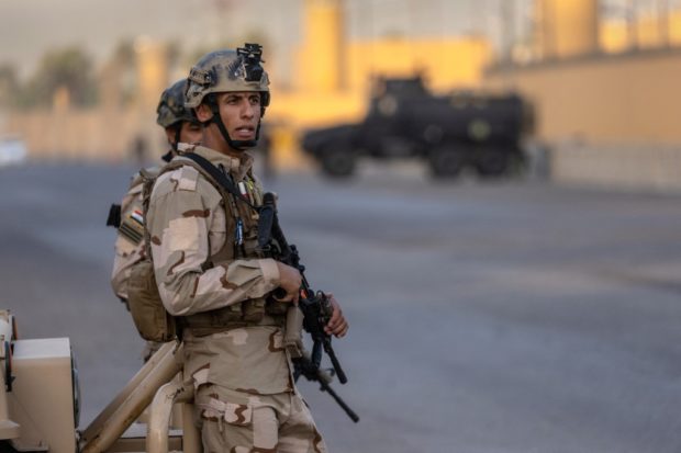 Iraqi Army soldiers stand guard on a road between the U.S. Embassy and the International Zone on May 30, 2021 in Baghdad, Iraq. Coalition forces based in Baghdad's International Zone are part of the U.S.-led Military Advisor Group of 13 nations supporting the Iraqi Security Forces. The United States currently maintains 2,500 military personnel in Iraq as part of Operation Inherent Resolve.