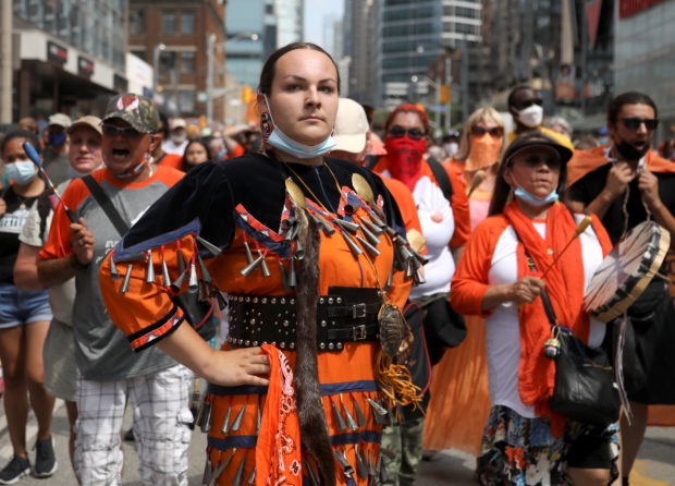 Indigenous performer Danielle Migwans attends a march after the discovery of hundreds of remains of children at former indigenous residential schools, on Canada Day in Toronto, Ontario, Canada July 1, 2021. REUTERS/Carlos Osorio