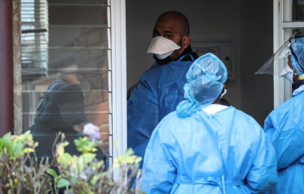 Anees Kara, a paramedic and project manager, treats a patient during the coronavirus disease (COVID-19) outbreak as the country faces tougher lockdown restrictions, at the MASA (Muslim Association of South Africa) Medpark in Johannesburg, South Africa, July 1, 2021. REUTERS/ Sumaya Hisham