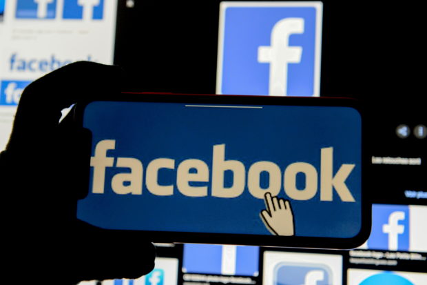 The Facebook logo is displayed on a mobile phone in this picture illustration taken December 2, 2019. REUTERS/Johanna Geron/Illustration/File Photo/File Photo