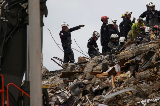 Rescue personnel continue the search and rescue operation for survivors at the site of a partially collapsed residential building in Surfside, near Miami Beach, Florida, U.S. June 30, 2021. REUTERS/Marco Bello/File Photo