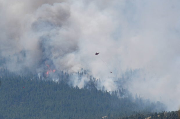 A wildfire burns outside of the town of Lytton, where it raged through and forced everyone to evacuate, in British Columbia, Canada, July 1, 2021.  REUTERS/Jennifer Gauthier
