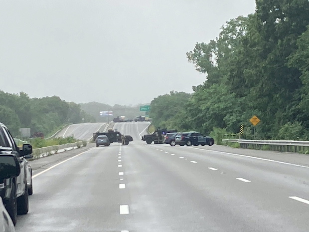 Massachusetts State Police vehicles block Route 95 during an armed standoff in Wakefield