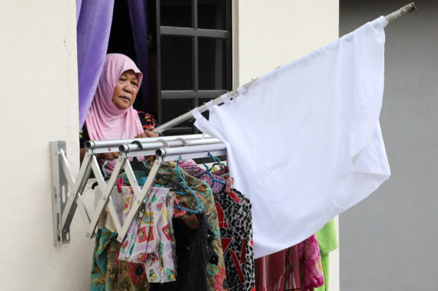 As lockdown bites, Malaysians hoist white flags in plea for help
