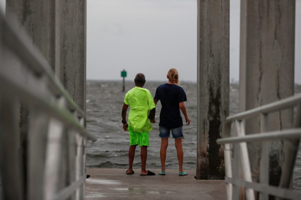 Way Williams, 65, and his wife Jennifer, 60, stand holding hands at Bay Vista Park, as Elsa strengthened into a Category 1 hurricane hours before an expected landfall on Florida's northern Gulf Coast, in St. Petersburg, Florida, U.S.