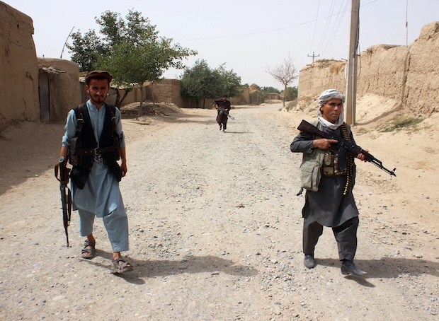 Armed Afghan militias patrol on the outskirts of Takhar province