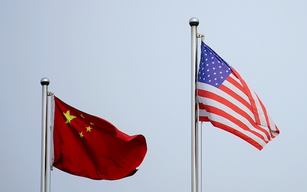 Chinese and U.S. flags flutter outside a company building in Shanghai