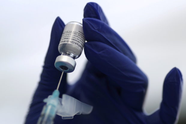 A healthcare worker prepares a Pfizer coronavirus disease (COVID-19) vaccination in Los Angeles, California, U.S., January 7, 2021.